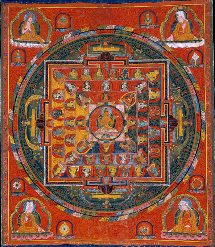 A densely painted Tibetan thangka on a red background featuring a central seated deity inside concentric circles and a square palace structure with four gates. Smaller figures of deities and lamas fill every section of the composition, with four robed figures seated in the corners. Gold, red, green and deep blue dominate the palette.