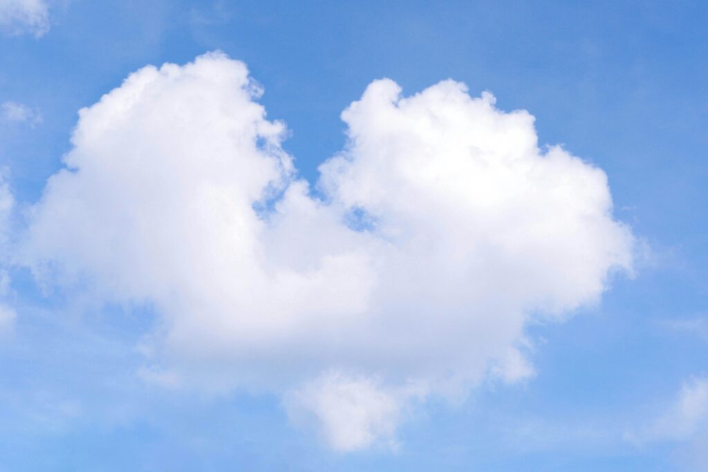 Heart-Shaped Cloud Against Blue Sky
