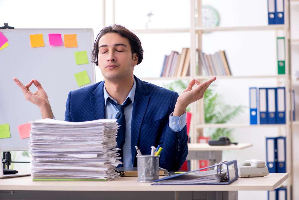 Young male employee unhappy with excessive work 