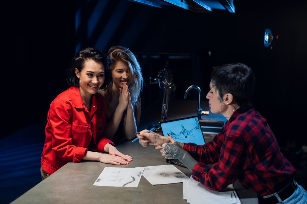 Two friends came to a tattoo parlor to get identical tattoos as a sign of friendship. Choose a sketch with the artist