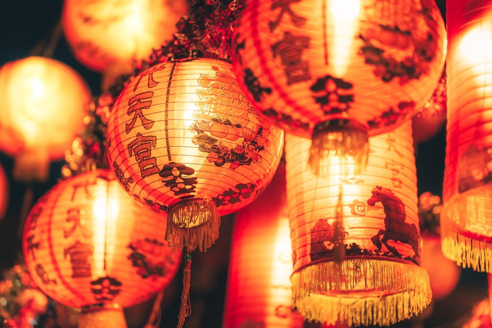 Red Chinese lantern(Translation Hieroglyph text Happy New Year) hanging in a row during day time for Chinese new year celebration.