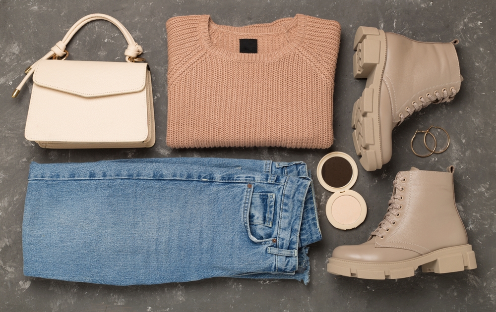 Flat lay with trendy spring outfit on concrete background, top view