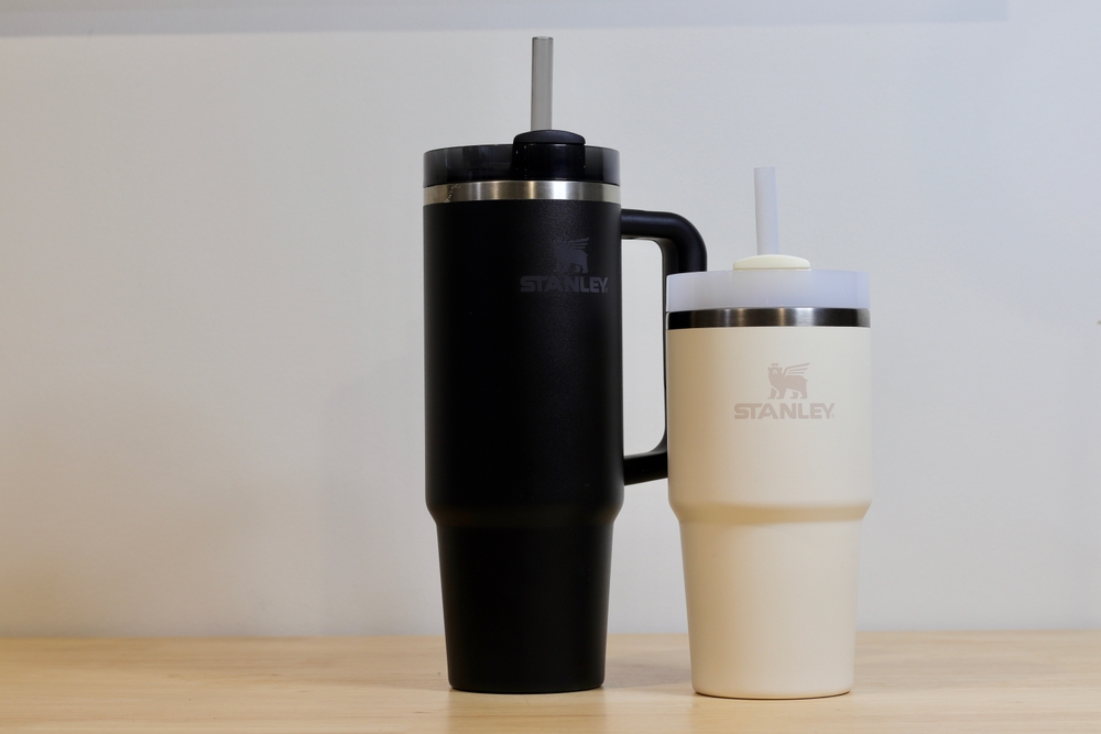 Barcelona, Spain - January 13 2025: Two Stanley Cups, one Black and one Beige. Insulated Tumblers, Reusable Straws, and Stainless Steel Accents