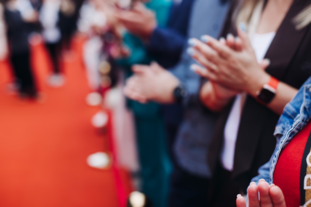 Red carpet with ropes and golden barriers on a luxury party entrance, cinema premiere film festival event award gala ceremony, wealthy rich guests arriving, outdoor decoration elements, summer day