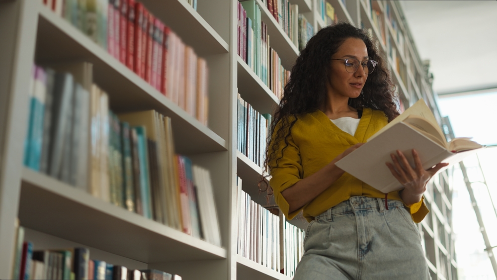 Hispanic Latina woman student library choosing books textbooks bookstore learning education female exam preparation girl read bookworm smart teacher reader archive lesson study high school university