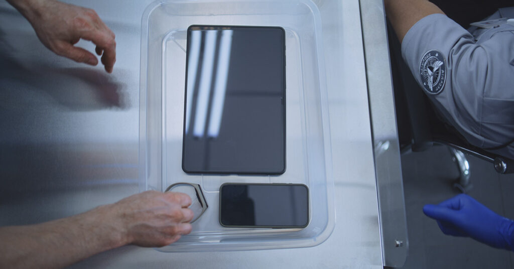 Why You Should Never Put Your Phone in the TSA Bin, According to Experts - Featured image