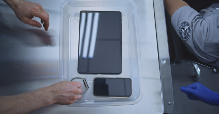 Why You Should Never Put Your Phone in the TSA Bin, According to Experts - Featured image