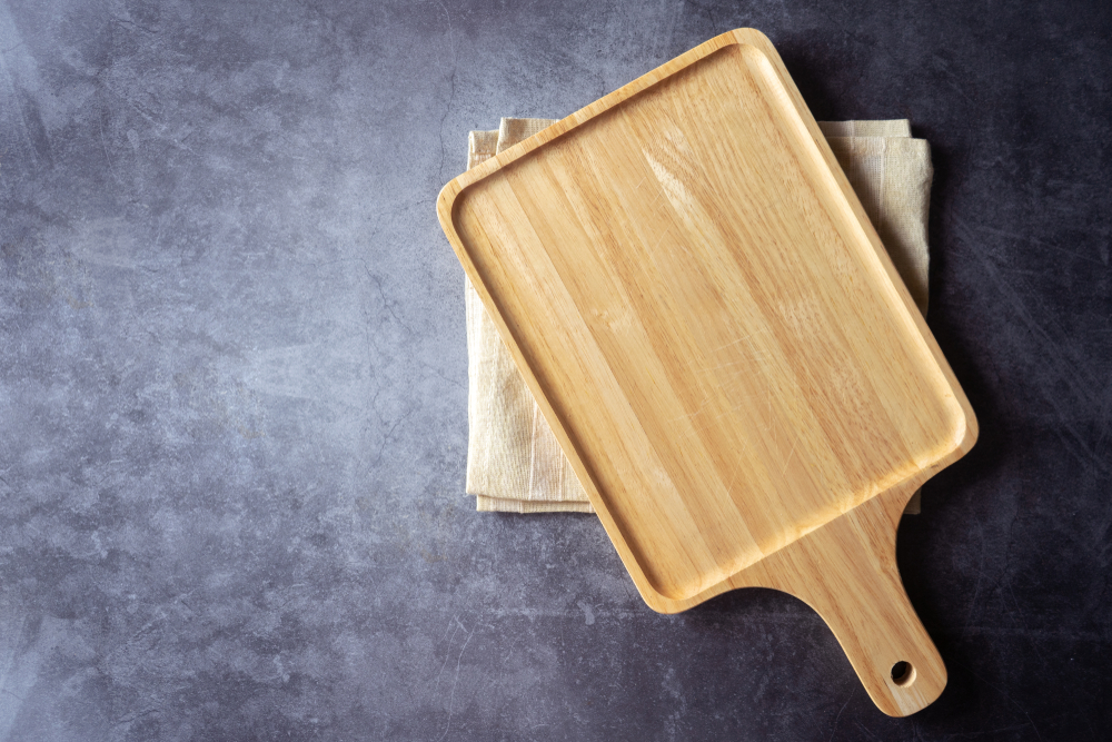 Vintage wood board with towel. Kitchen cooking concept. Space for text