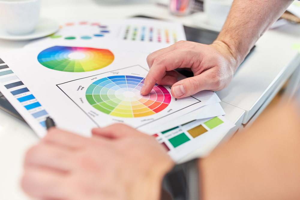 Graphic designer points to the color palette when discussing graphic design