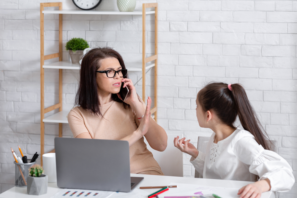 Parenting problems during coronavirus. Busy working mother having no time for her bored daughter, answering business phone call at home. Teen girl feeling neglected by her mom during lockdown