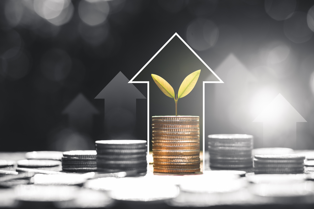 The coins are stacked with white technology icons at the top, financial growth concepts.