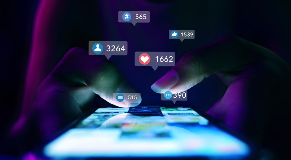 Finger of woman touching scroll page app on mobile phone.In a room with blue and purple neon tones.concept Social Media, Marketing, Post - Structure, Image-based Social Media, like buttons