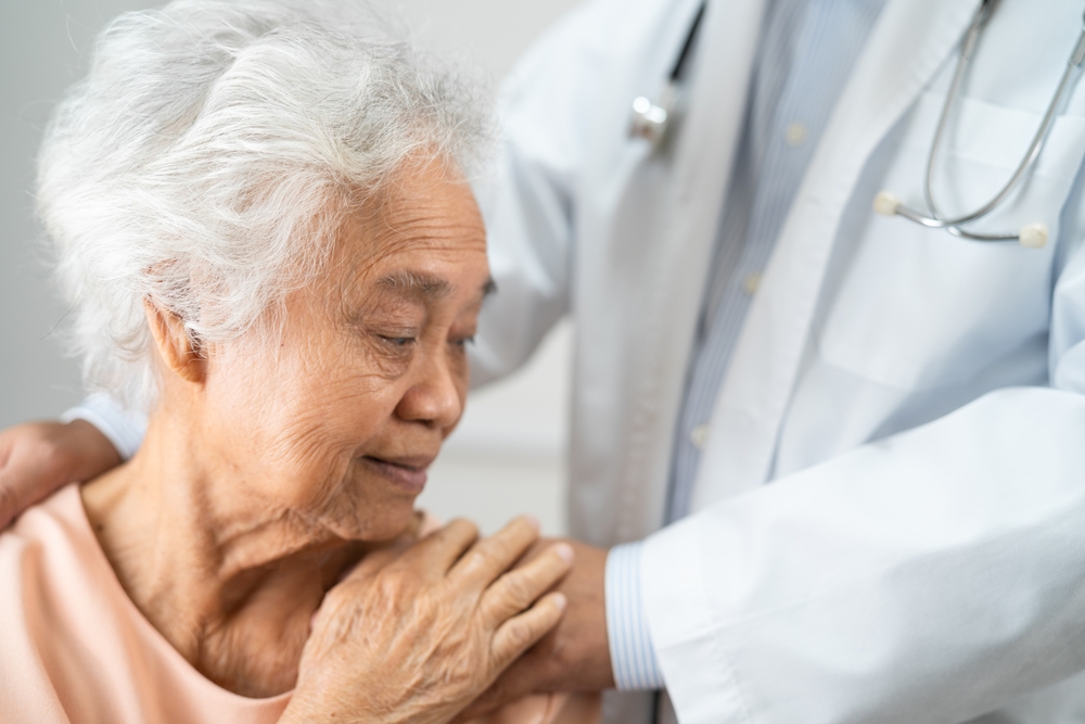 Caregiver holding hands Asian elderly woman patient with love, care, encourage and empathy at nursing hospital, healthy strong medical concept.