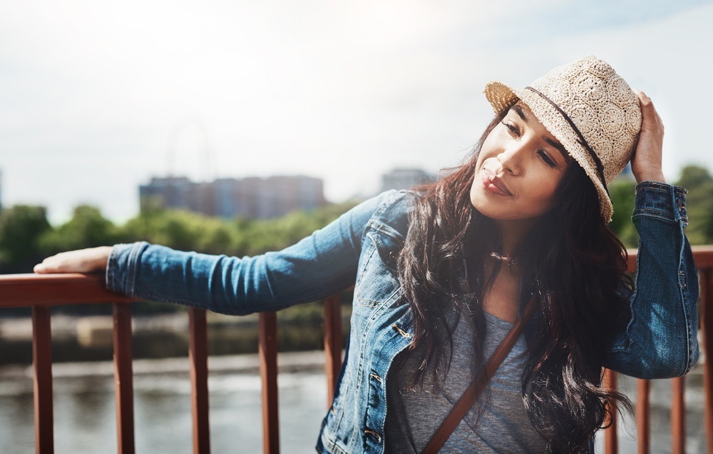Thinking, tourist and woman on holiday, city and planning for adventure, sightseeing or calm on trip. Outdoor, reflection and person with decision on break, travel and thoughtful on summer vacation