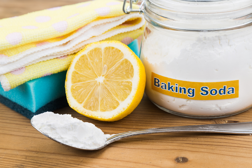 Baking soda, lemon with sponge and towel for effective and safe house cleaning