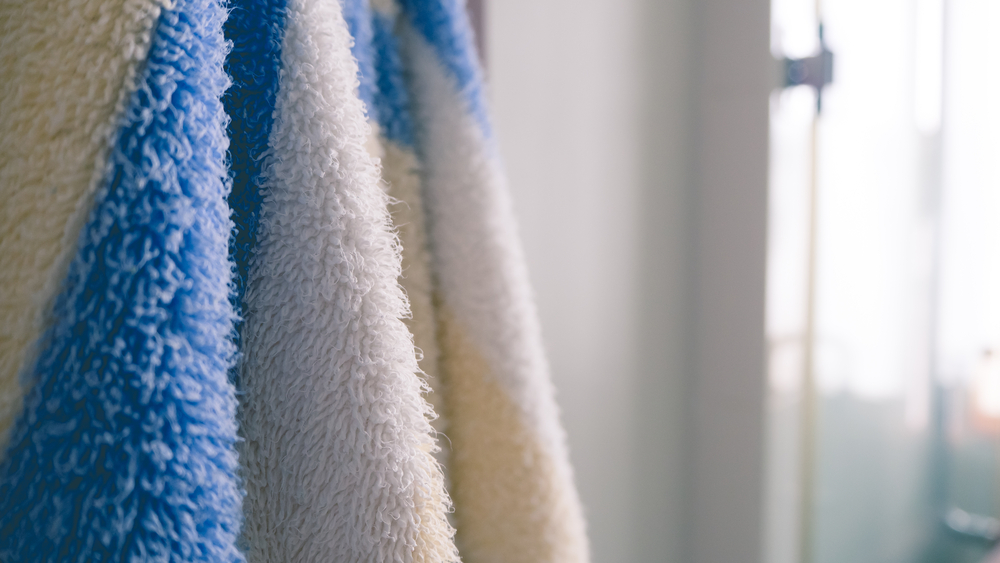 Close up of hanging towels in bathroom.