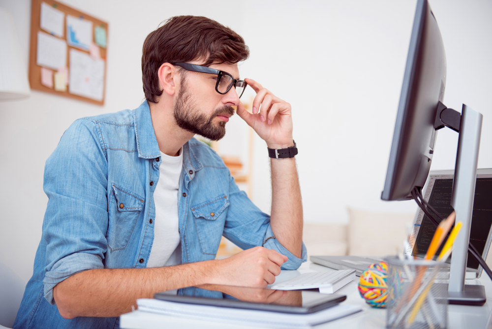 Man looking at screen of computer
