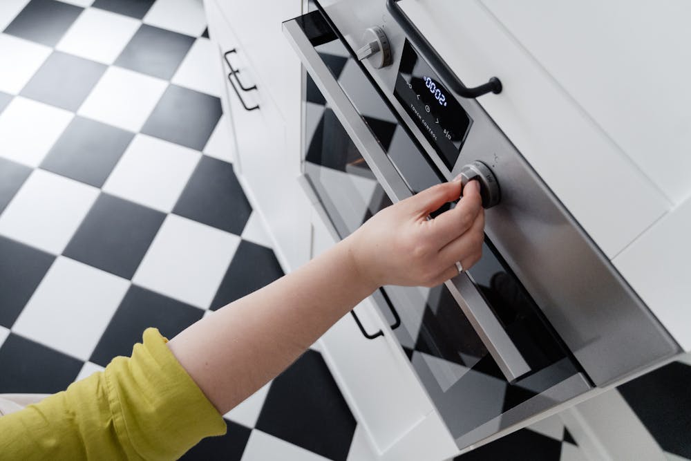 black and white kitchen floor, oven turning dial for temperature