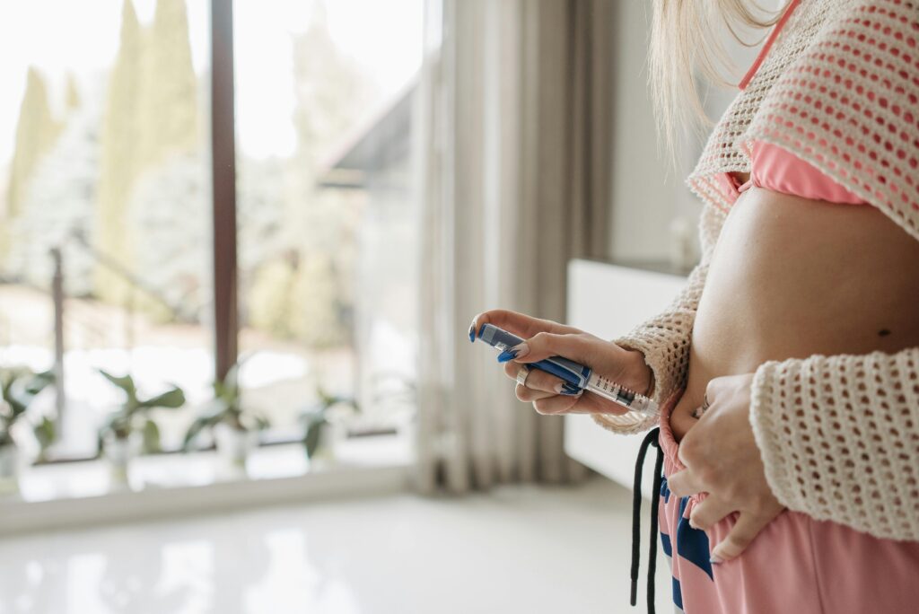 woman using subcutaneous injection Ozempic on stomach
