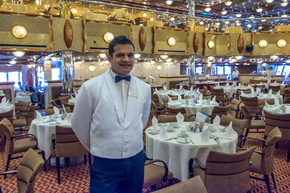More og Romsdal, Norway - august 6, 2018: Waiter in white uniform at the restaurant of a cruise ship traveling through the Norwegian Fjords