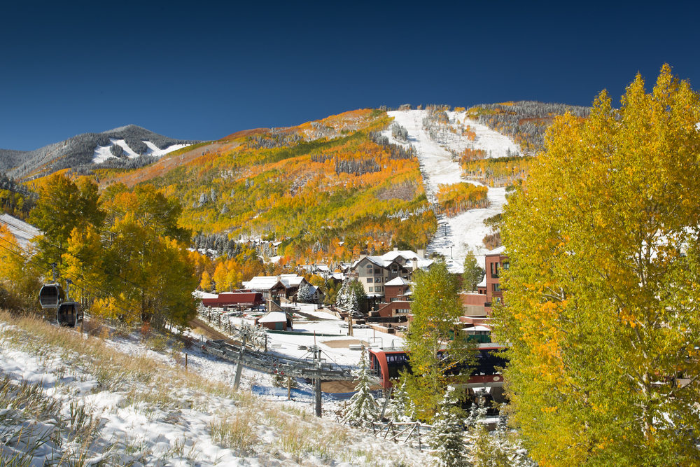 Snow on Golden Aspen Trees at Beaver Creek Resort, in Colorado with Ski Slopes and Gondola in Foreground
