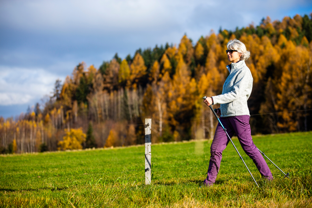 Healthy and active lifestyle of older people. Mature woman on a mountain trip. 
