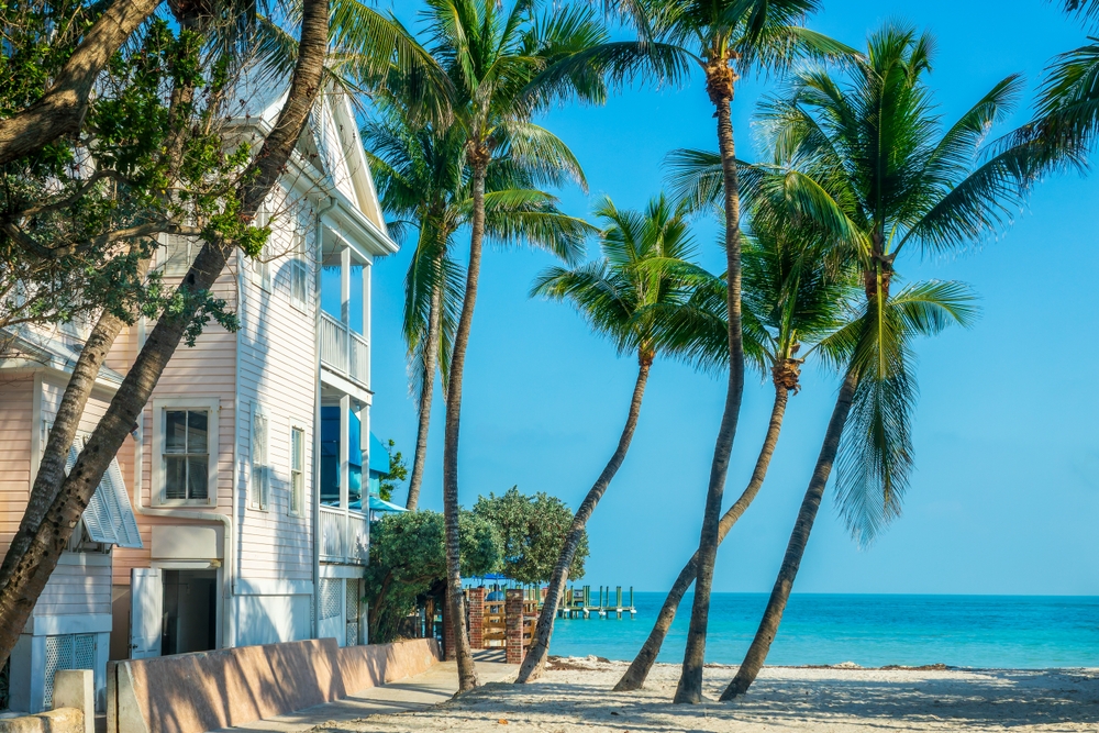 House with view on the ocean, palm trees on the beach, scenic landscape in Key West, Florida