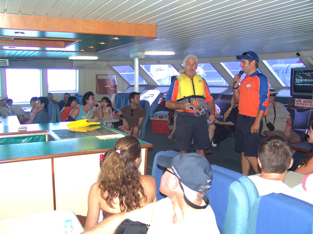                                
31 December, 2005, Sydney, Australia. Sydney.  Cruise security officials wearing in orange life jacket training passangers on water safety training on ship dock. 
