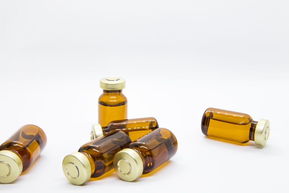 Six transparent ampules of water drug for injection such as dexamethasone or other steroids in isolated white background