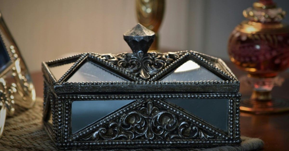 A beautifully ornate jewelry box with intricate designs, perfect for decoration or gifting.