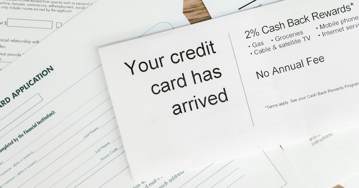 Close-up of a letter announcing the arrival of a credit card amidst financial documents.