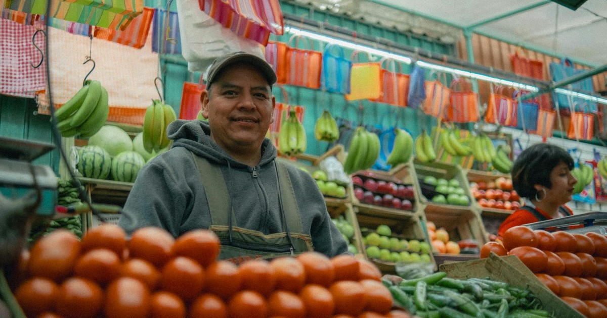 Colorful Mexican market with fresh fruits and vegetables and local vendors.