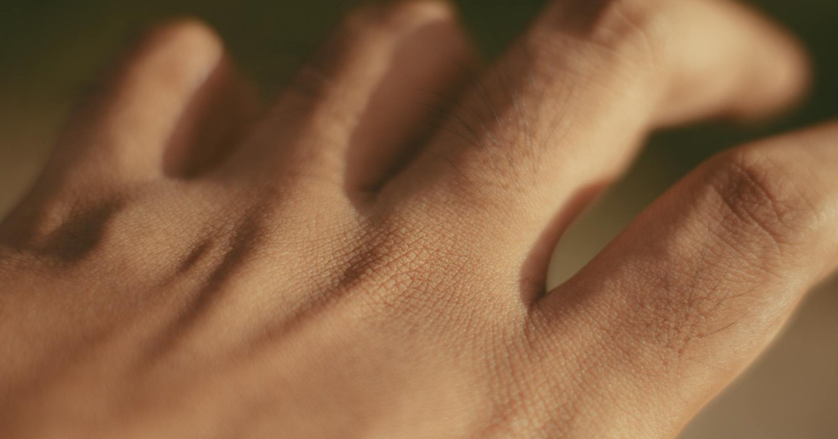 Macro shot of a human hand focusing on skin texture and pores in natural light.