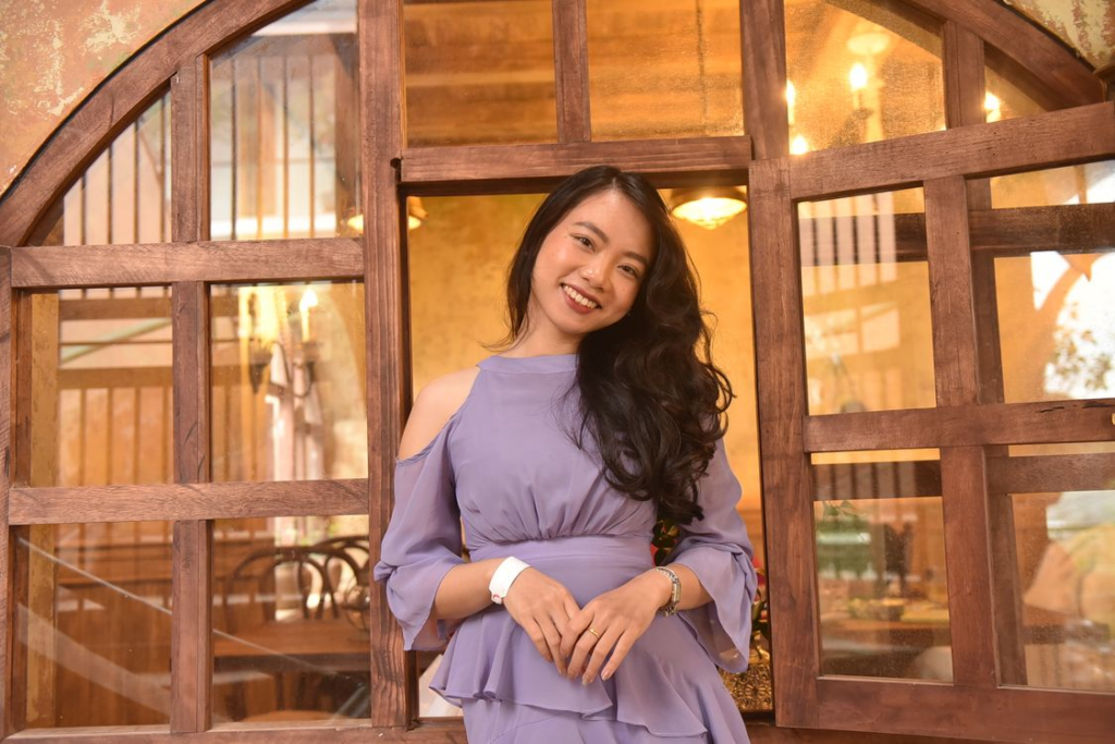 Asian woman in purple cold shoulder top