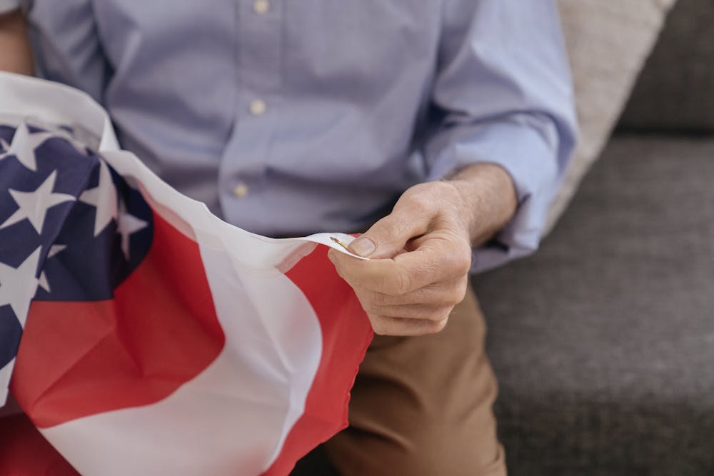 older man with American flag in hands