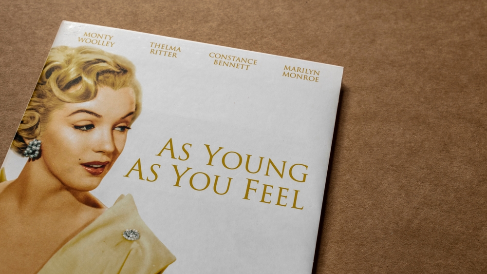  30 May 2025 - Limerick, Ireland. 'As Young As You Feel' movie; DVD edition; cover featuring 'Marilyn Monroe'; cast; isolated on blank background, top angle shot.