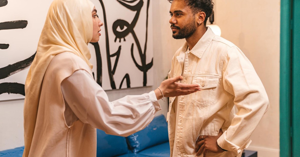 A man and woman in an intense conversation at home, evoking emotions.
