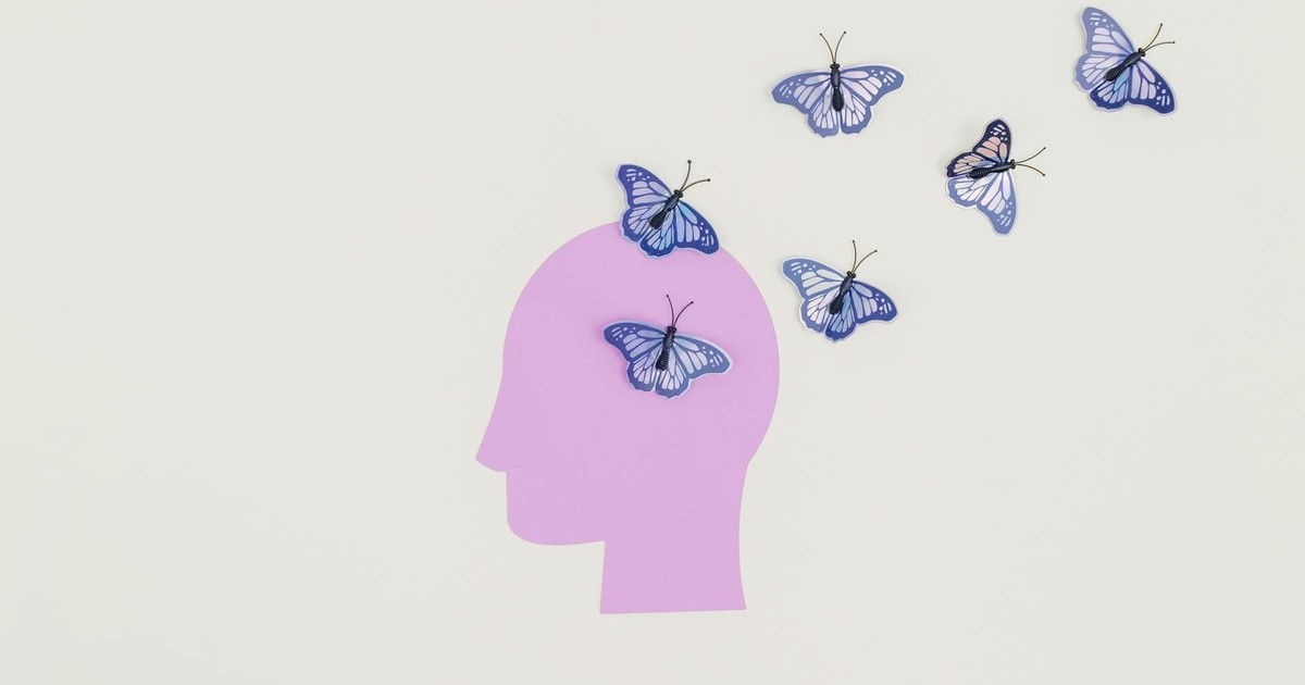 Abstract art of butterflies emerging from a silhouette head representing imagination and freedom.