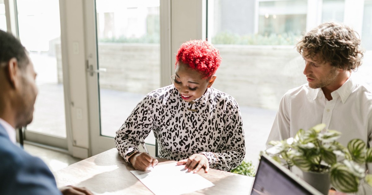 Diverse professionals reviewing documents in a bright, modern office setting.