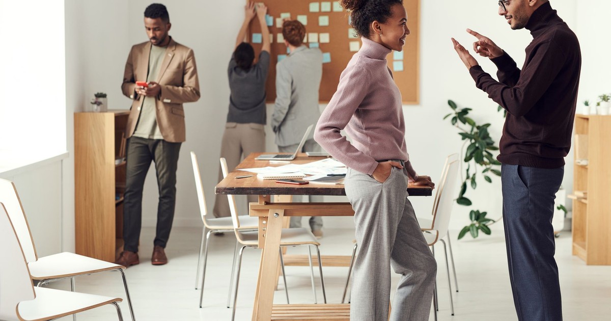 Colleagues engaging in teamwork and brainstorming in a modern office space.