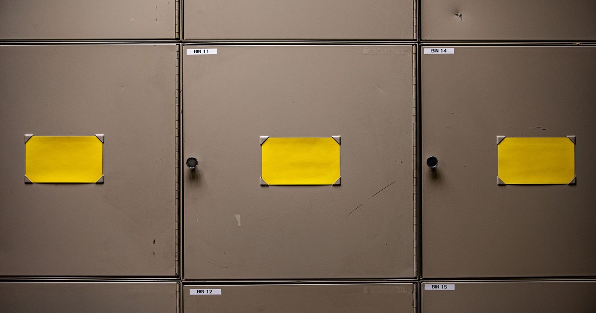 Steel cabinets with yellow labels for organization in an interior setting.