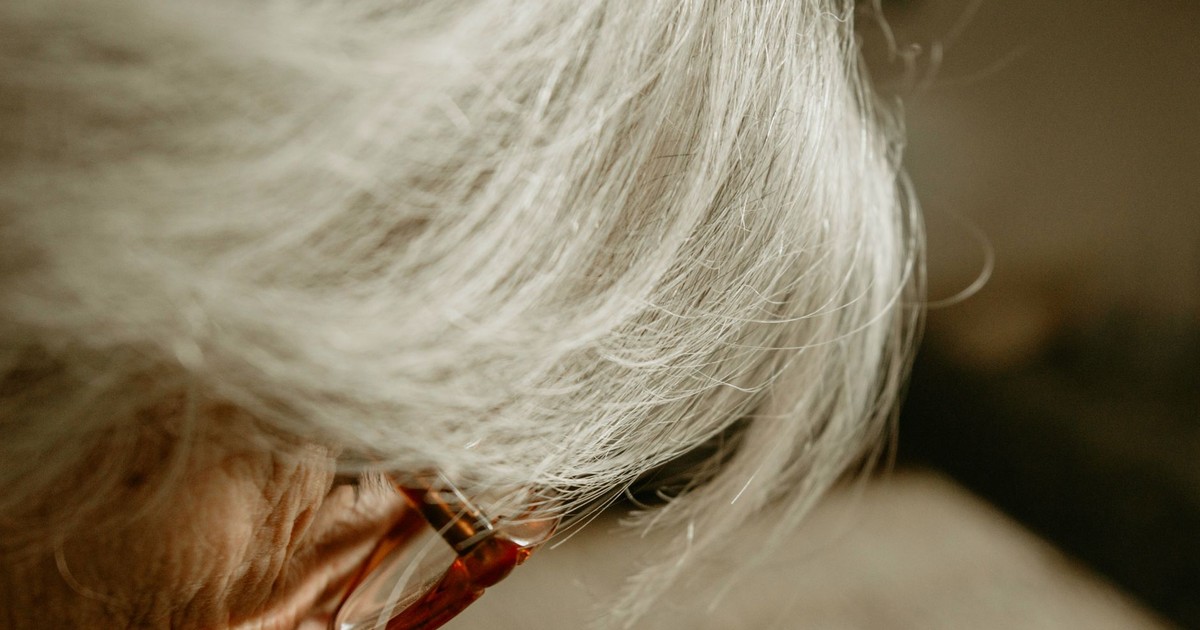 A focused close-up of a senior adult wearing glasses, highlighting wisdom and experience.