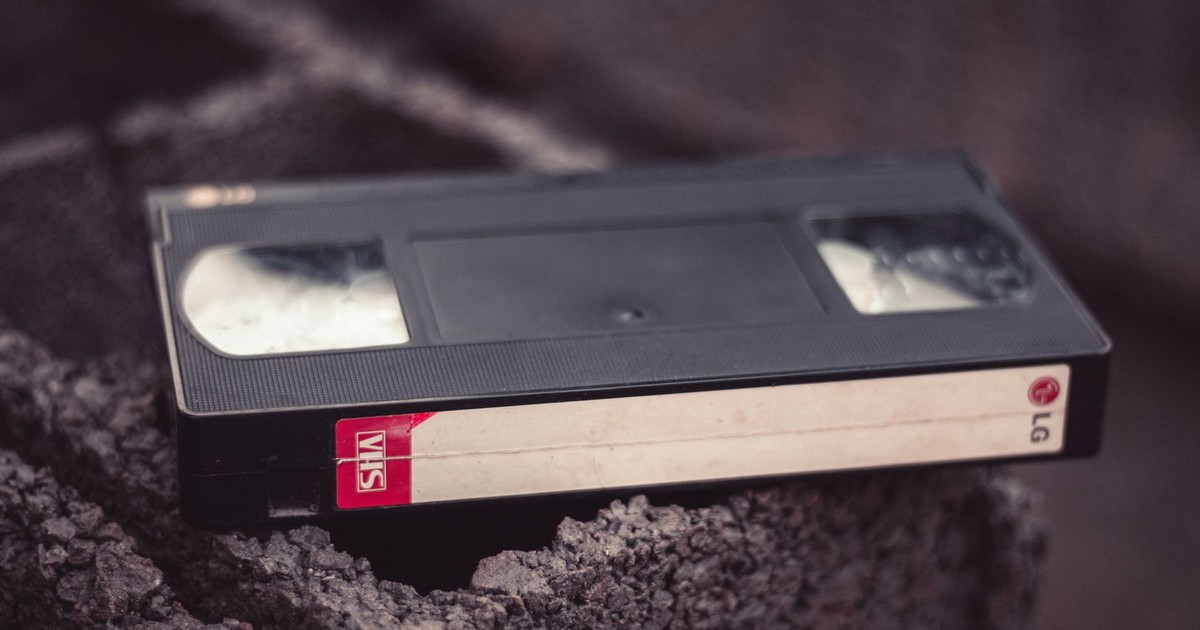 Close-up of a vintage VHS tape resting on a textured surface, offering nostalgic appeal.