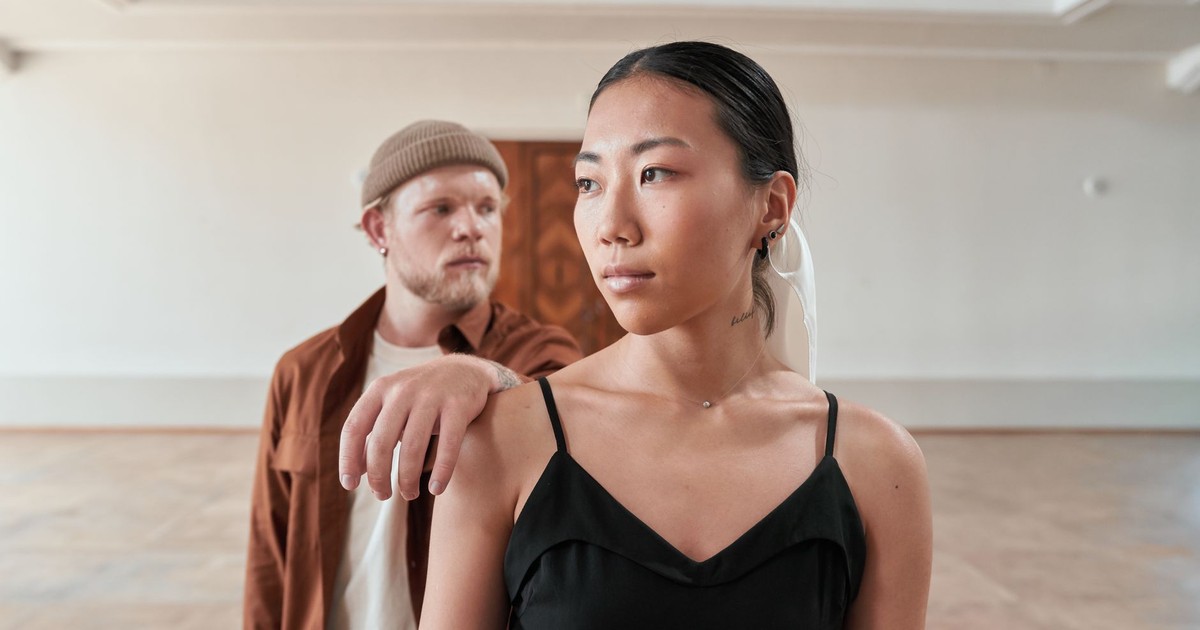Portrait of an Asian woman and Caucasian man in a serene, contemplative setting.