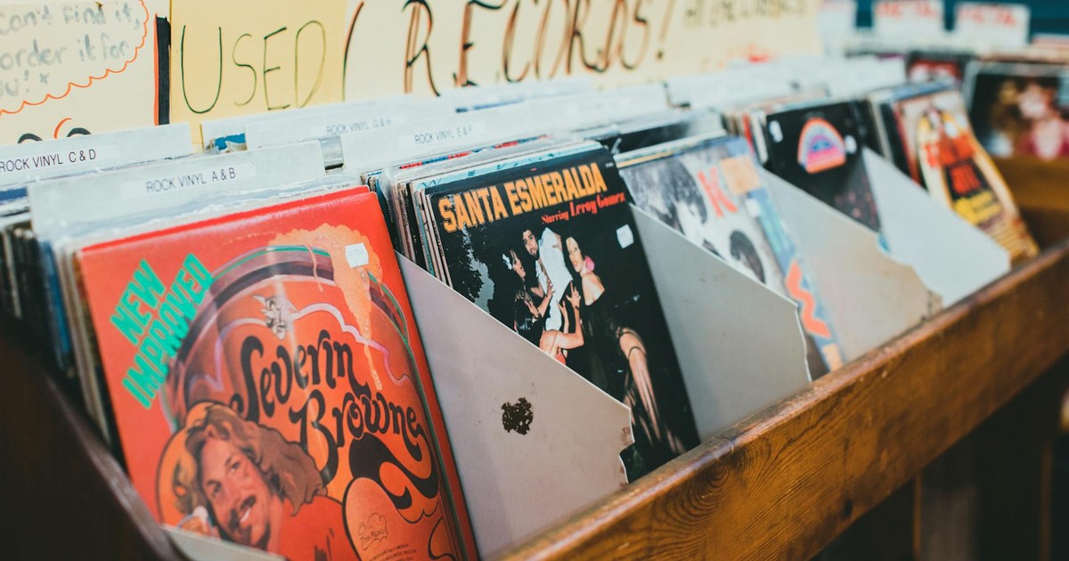 Close-up of vintage vinyl records in a music store display, emphasizing classic album covers.