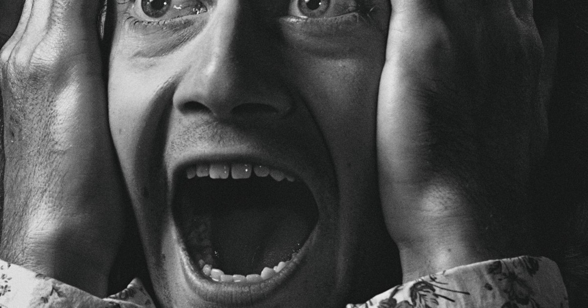 Close-up of a person in expressive shock, black and white portrait.
