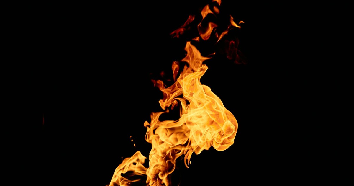 A vivid depiction of orange flames dancing against a dark backdrop, showcasing dynamic fire patterns.
