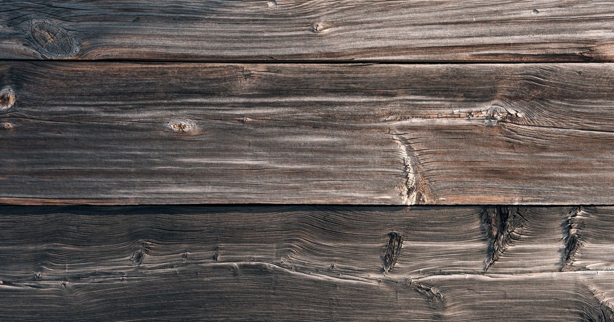 From above texture of aged shabby wooden table made of natural lumber panels as abstract background