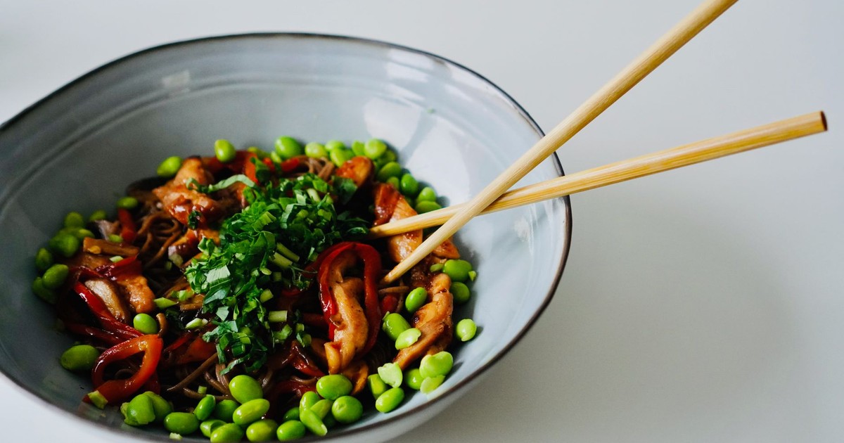 Explore this vibrant chicken noodle bowl with fresh vegetables, perfect for a healthy meal.