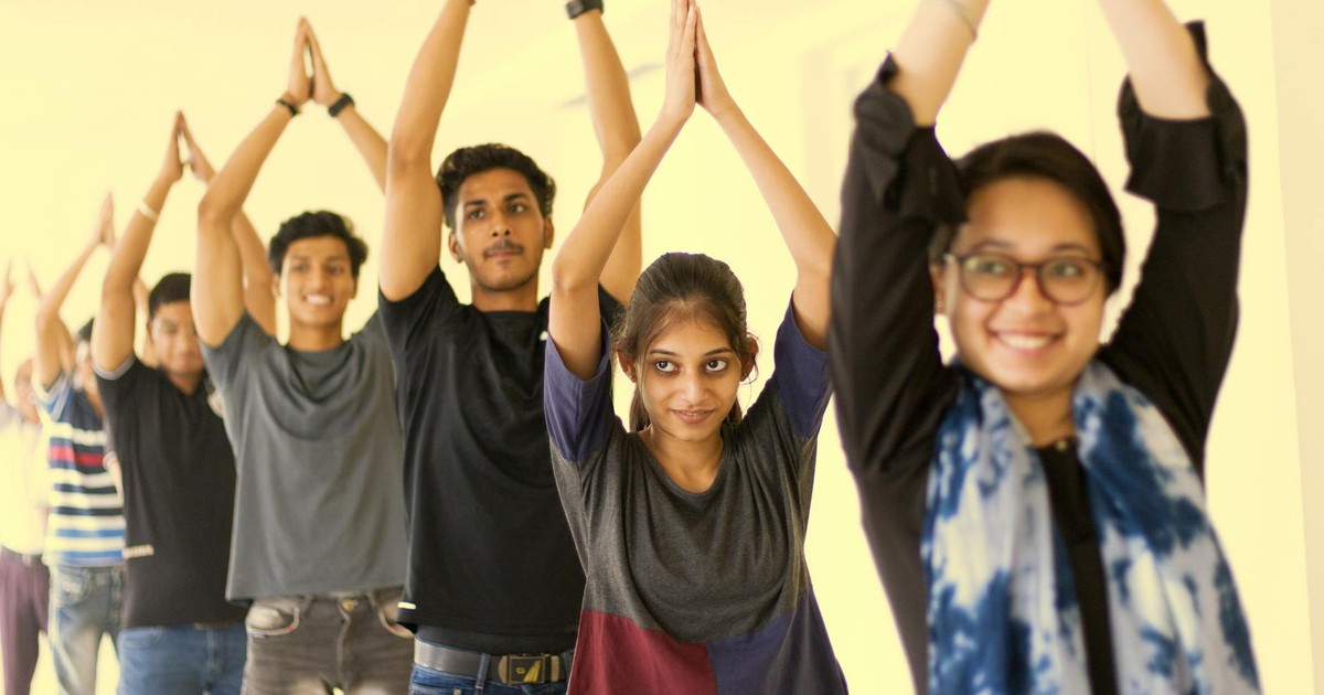 A vibrant group of young adults in a yoga class exuding enthusiasm and concentration.